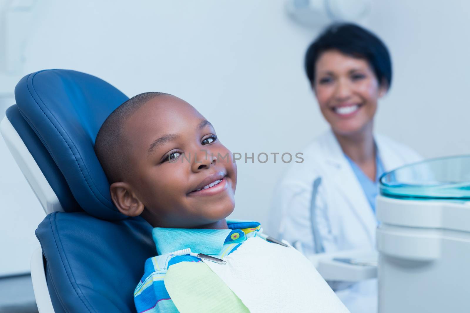 Smiling boy waiting for a dental exam  by Wavebreakmedia