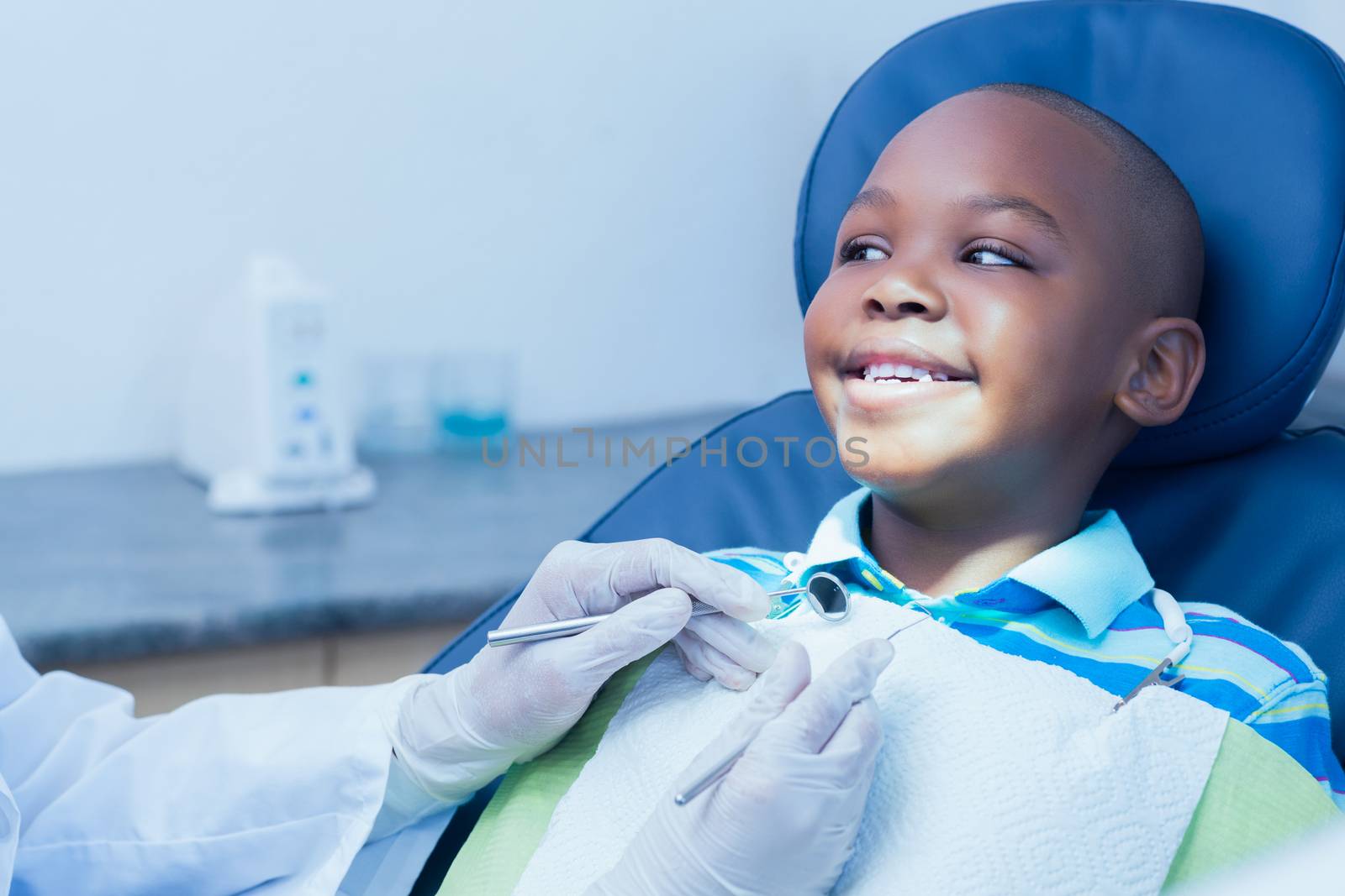 Close up of boy having his teeth examined by a dentist