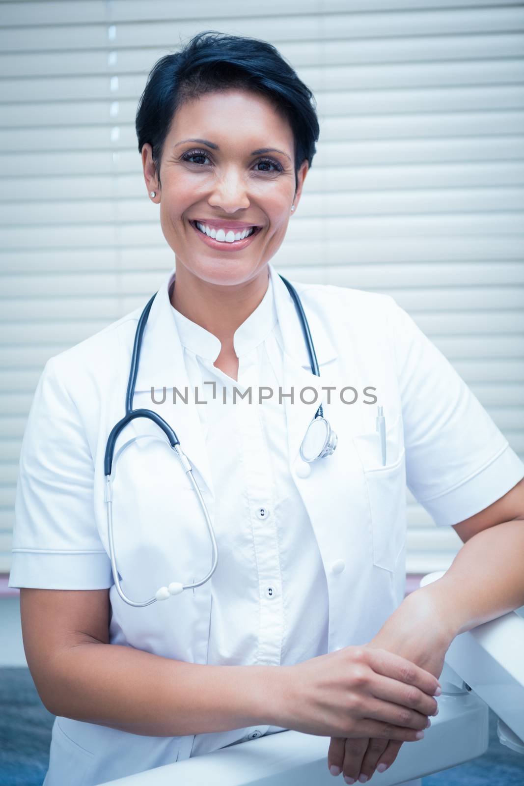 Confident smiling female dentist by Wavebreakmedia