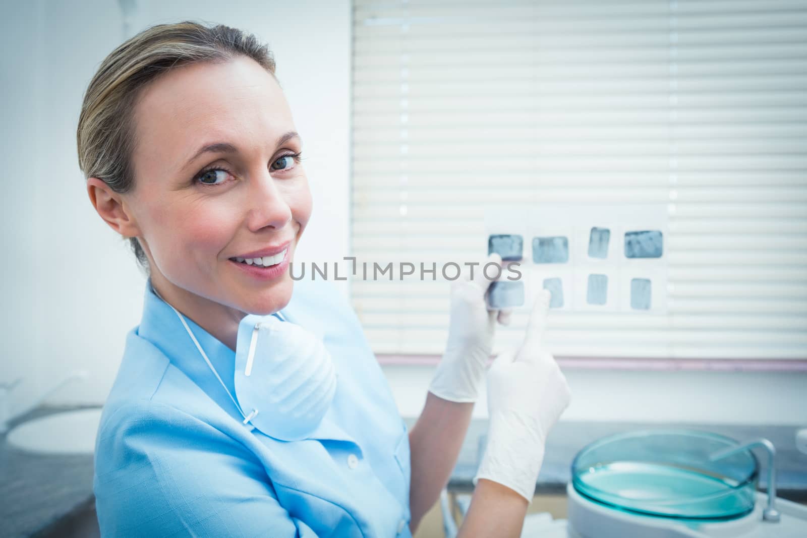 Portrait of female dentist holding x-ray by Wavebreakmedia