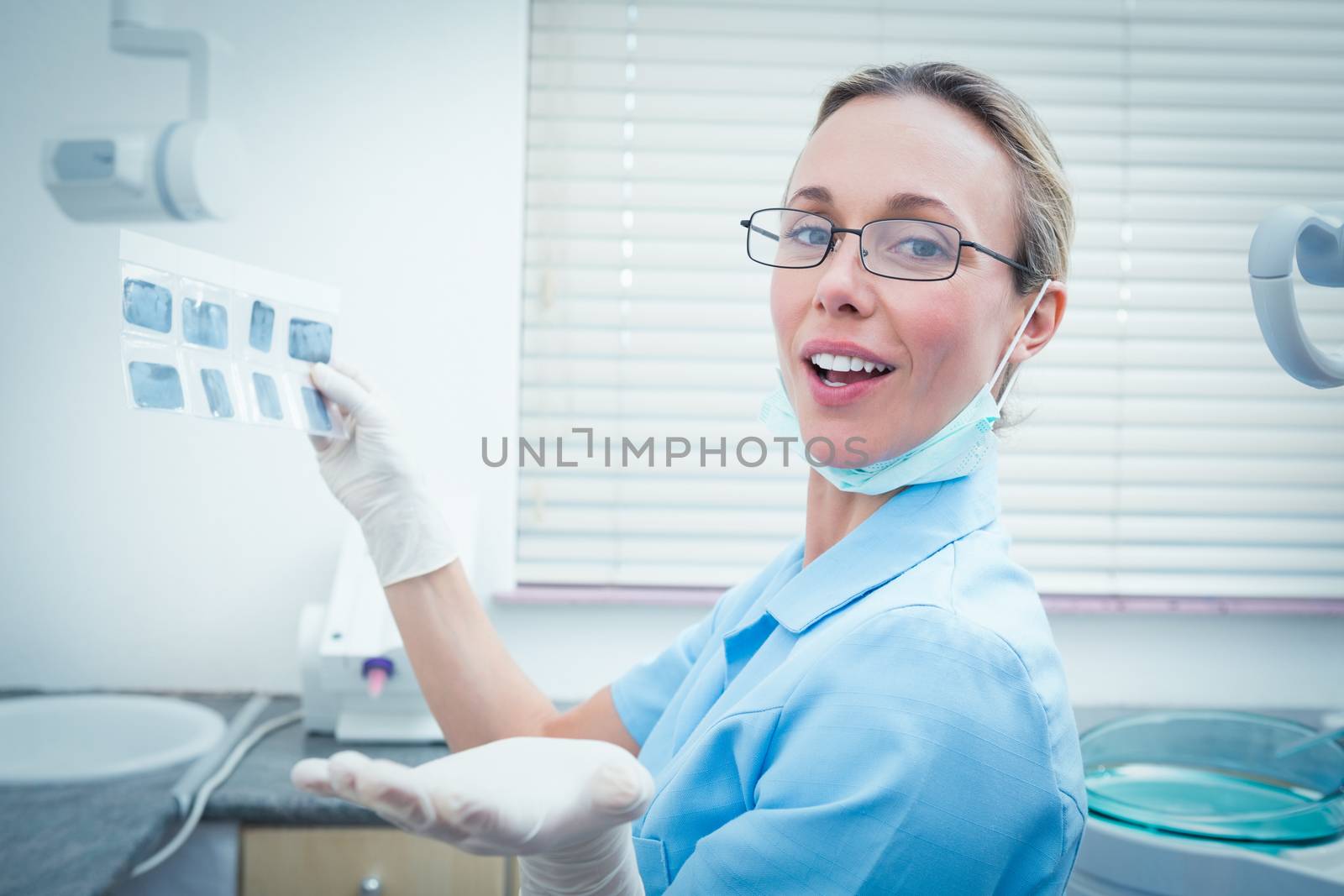 Female dentist holding x-ray by Wavebreakmedia