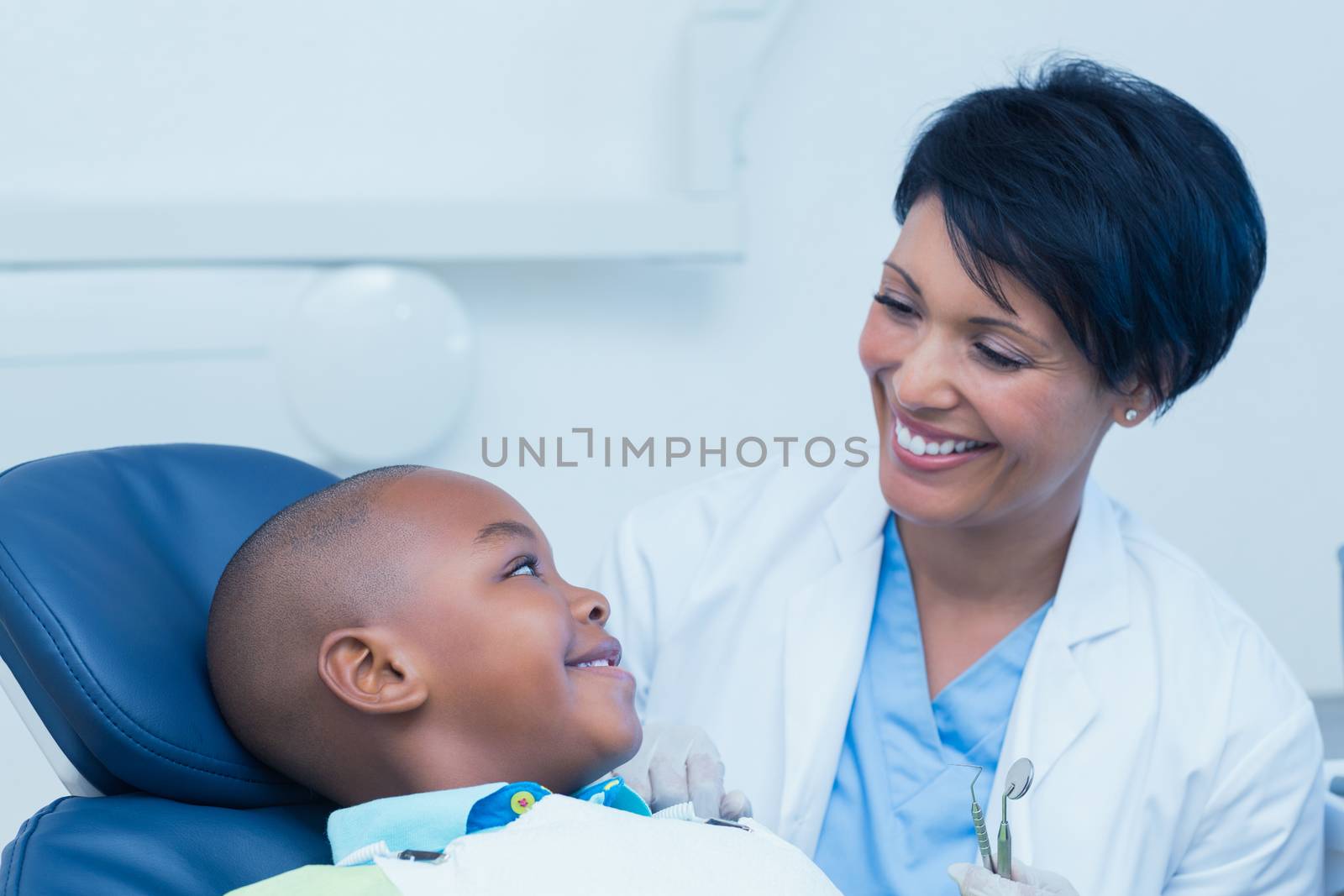 Side view of smiling boy waiting for a dental exam 