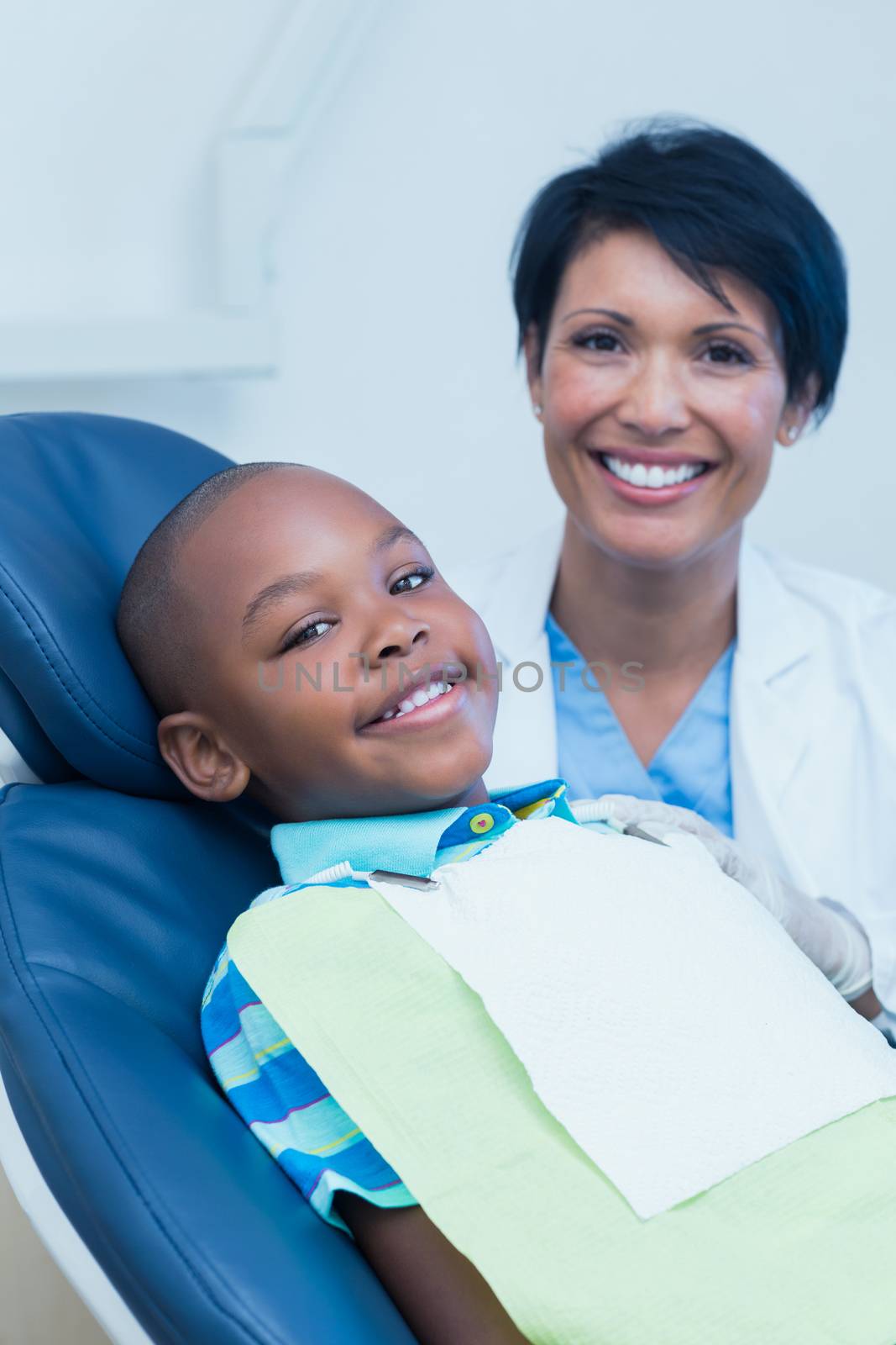 Smiling boy waiting for dental exam  by Wavebreakmedia