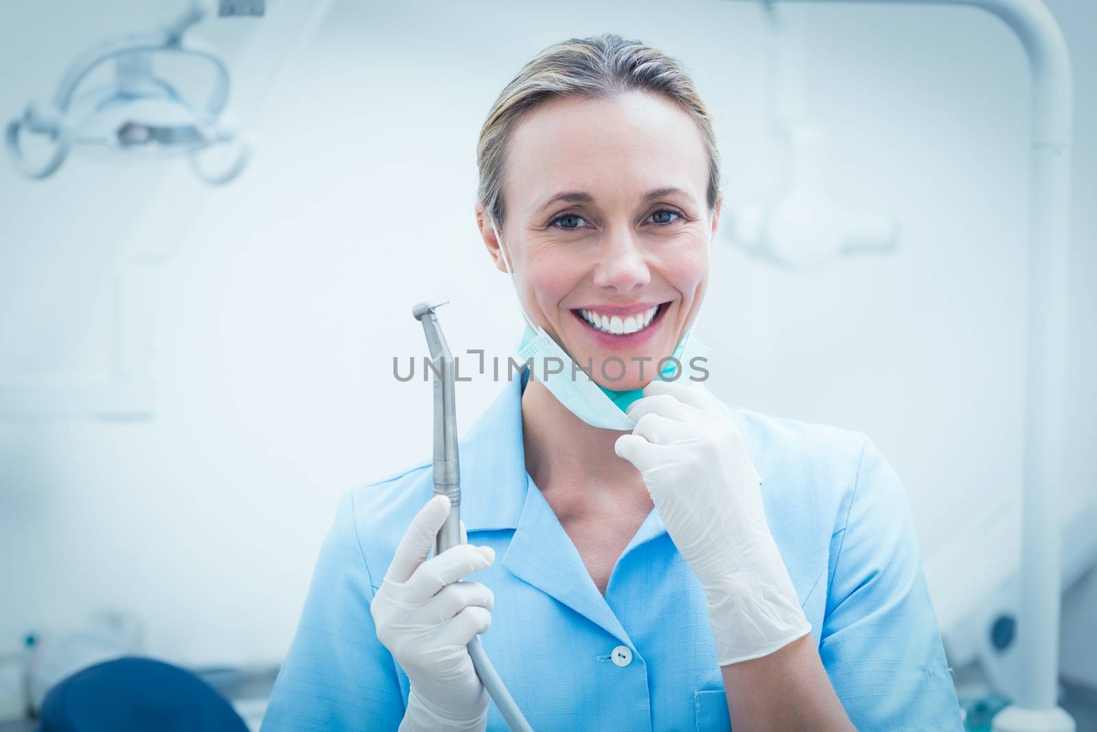 Female dentist holding dental tool by Wavebreakmedia
