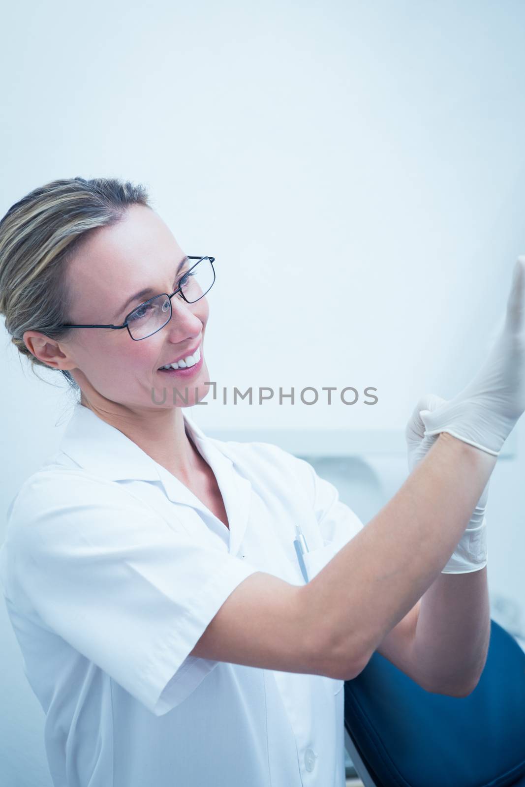 Portrait of female dentist wearing surgical glove