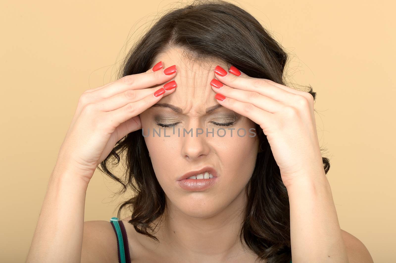 Attractive Young Woman With a Painful Headache Holding Her Head