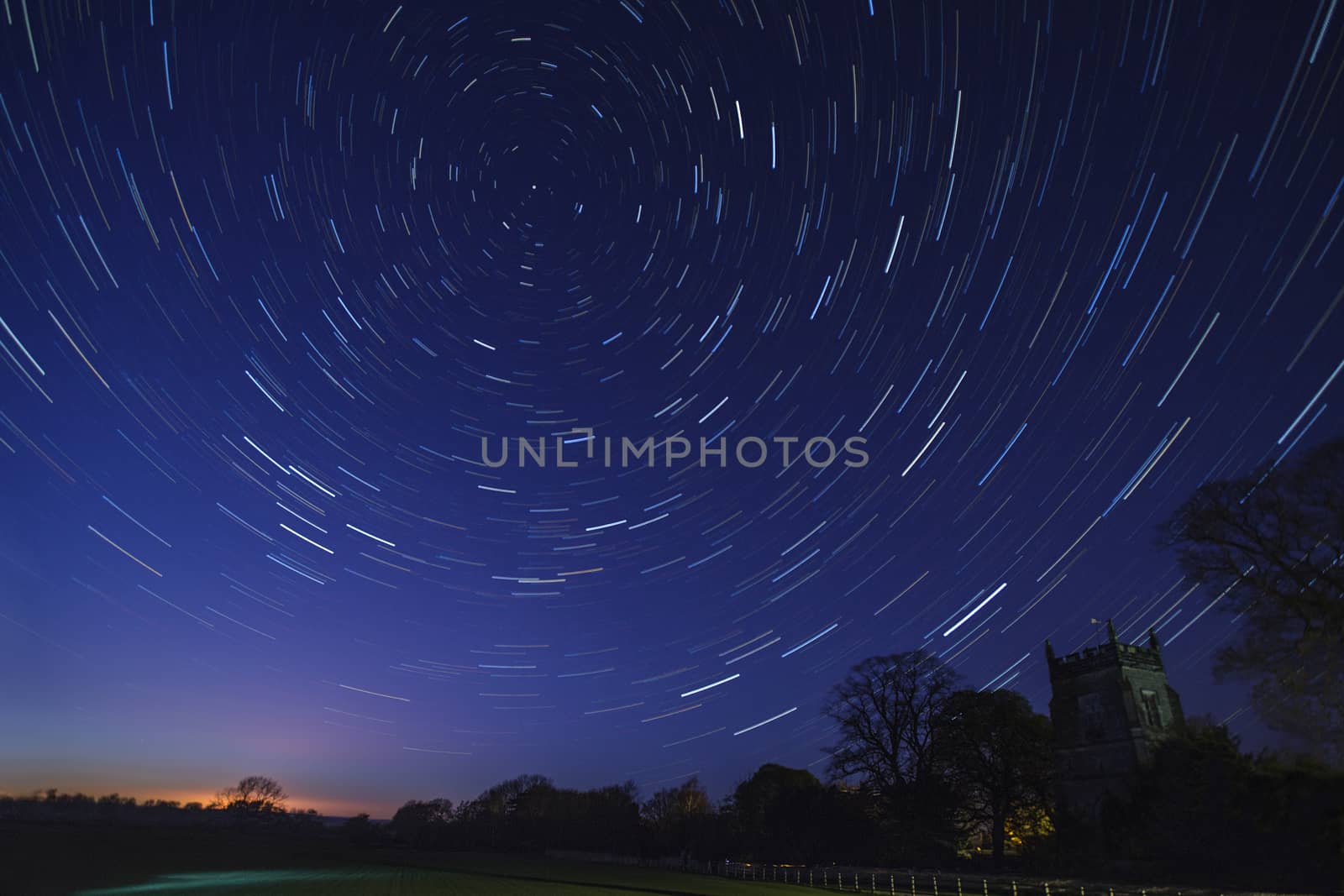 Astronomy - Star Trails in early Spring above a village church in a small village in North Yorkshire in the United Kingdom.