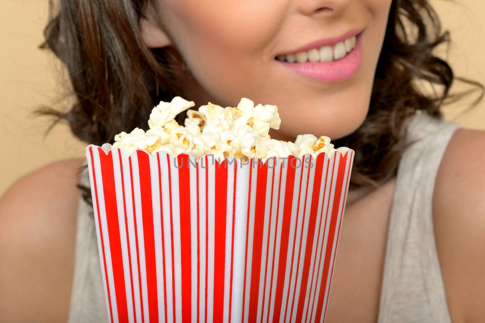 Attractive Beautiful Young Woman Portrait Eating Popcorn by Whiteboxmedia