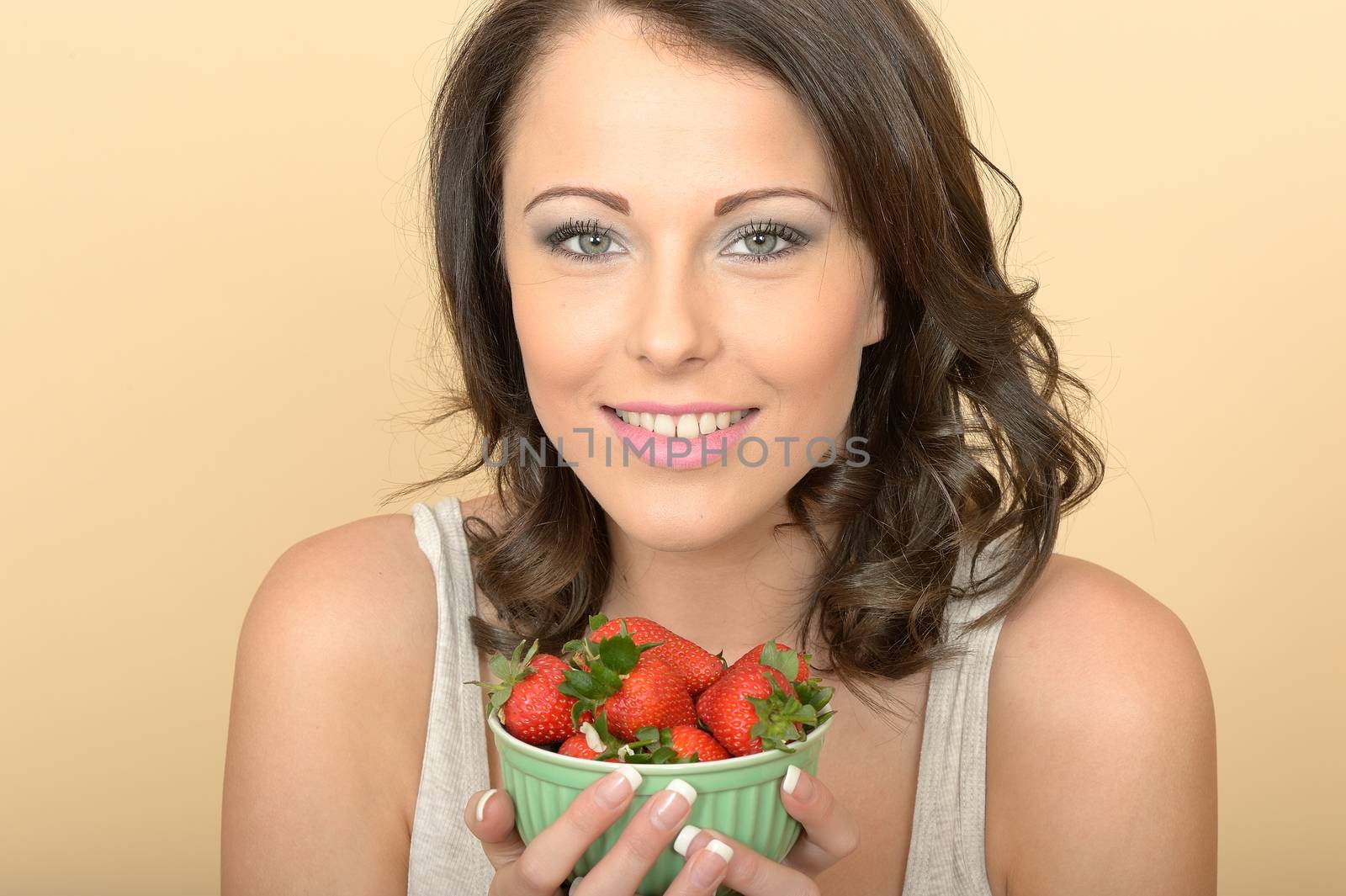Attractive Beautiful Young Woman Looking at the Camera Eating Fresh Ripe Juicy Strawberries