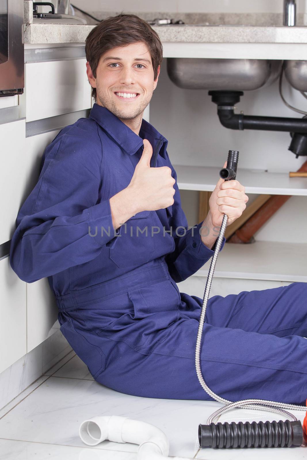 Happy plumber with his finger up