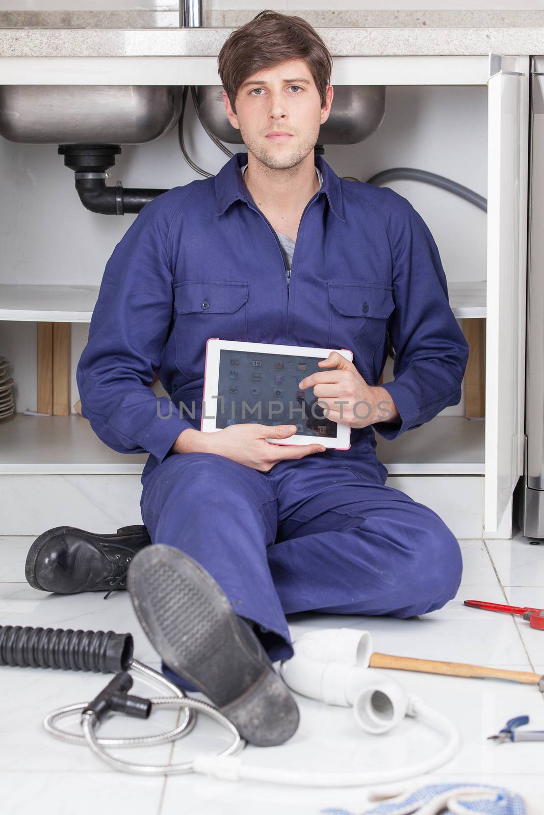 Serious plumber with his tablet