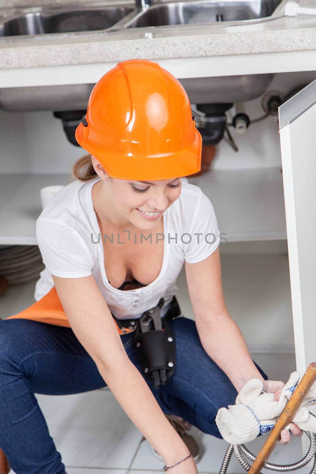 Plumber working in the kitchen