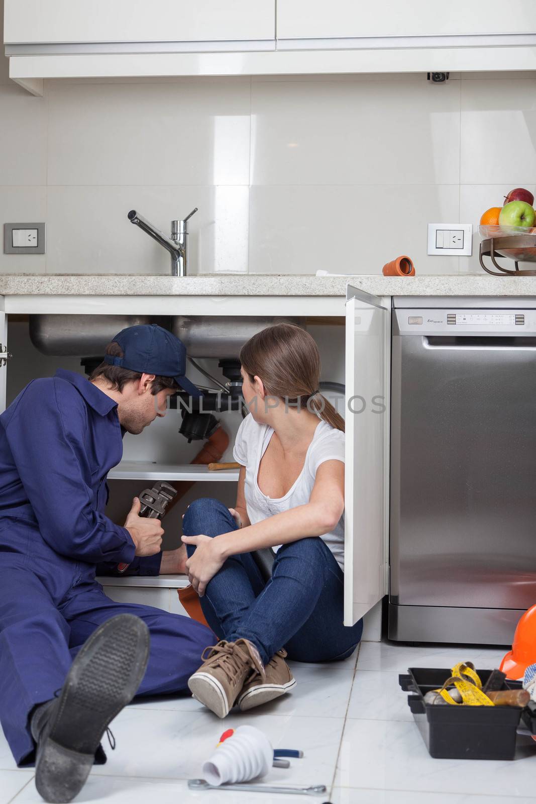 Couple plumbers fixing the pipes