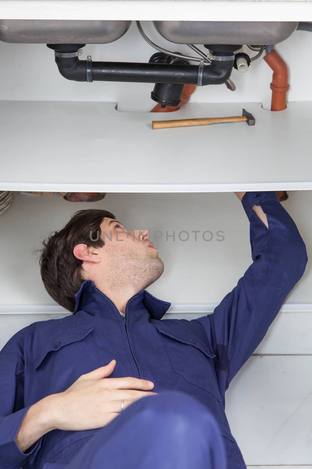 Plumber fixing the pipe