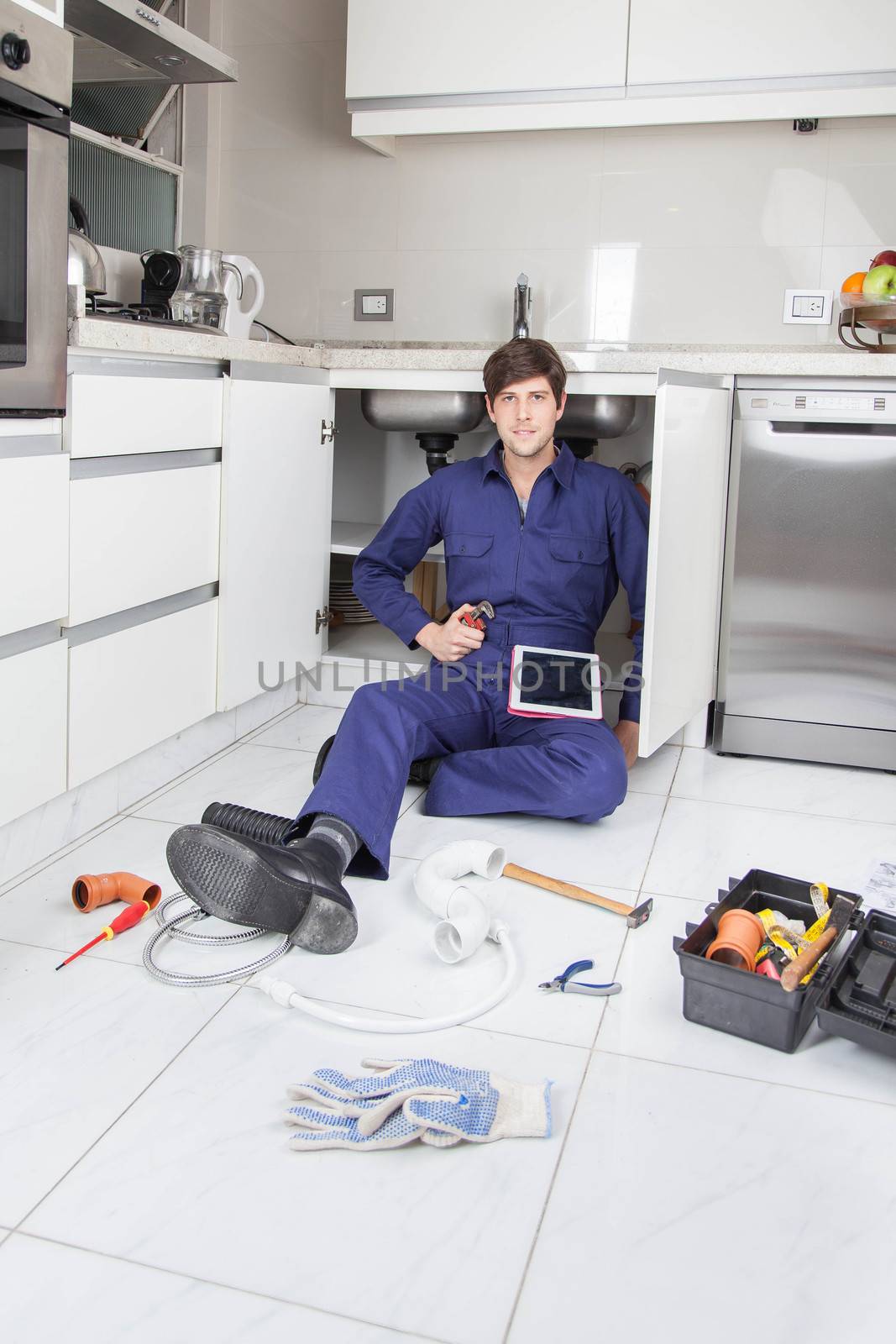 Plumber looking at the instructions in your tablet by ifilms