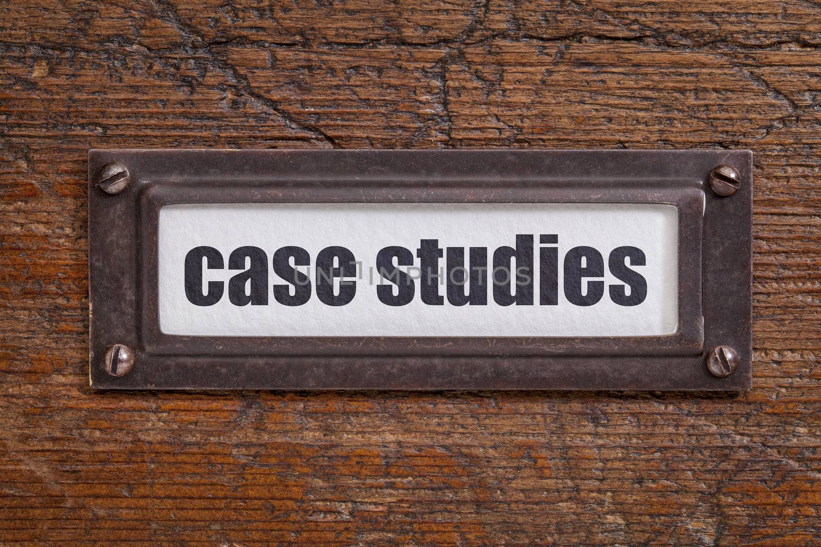 case studies  - file cabinet label, bronze holder against grunge and scratched wood