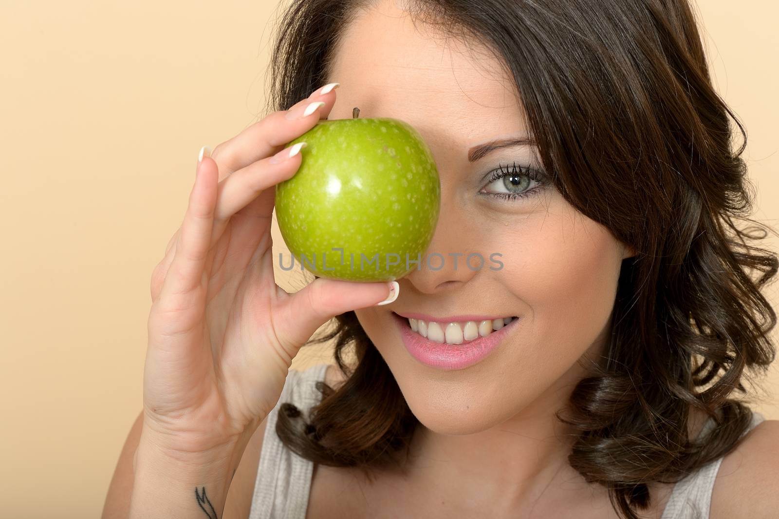 Attractive Beautiful Young Woman Holding Fresh Ripe Juicy Green  by Whiteboxmedia