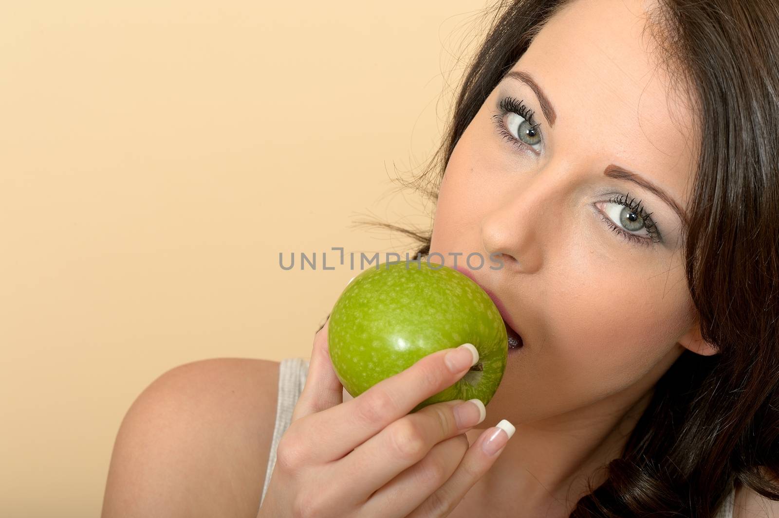 Attractive Beautiful Young Woman Eating a Fresh Juicy Green Apple