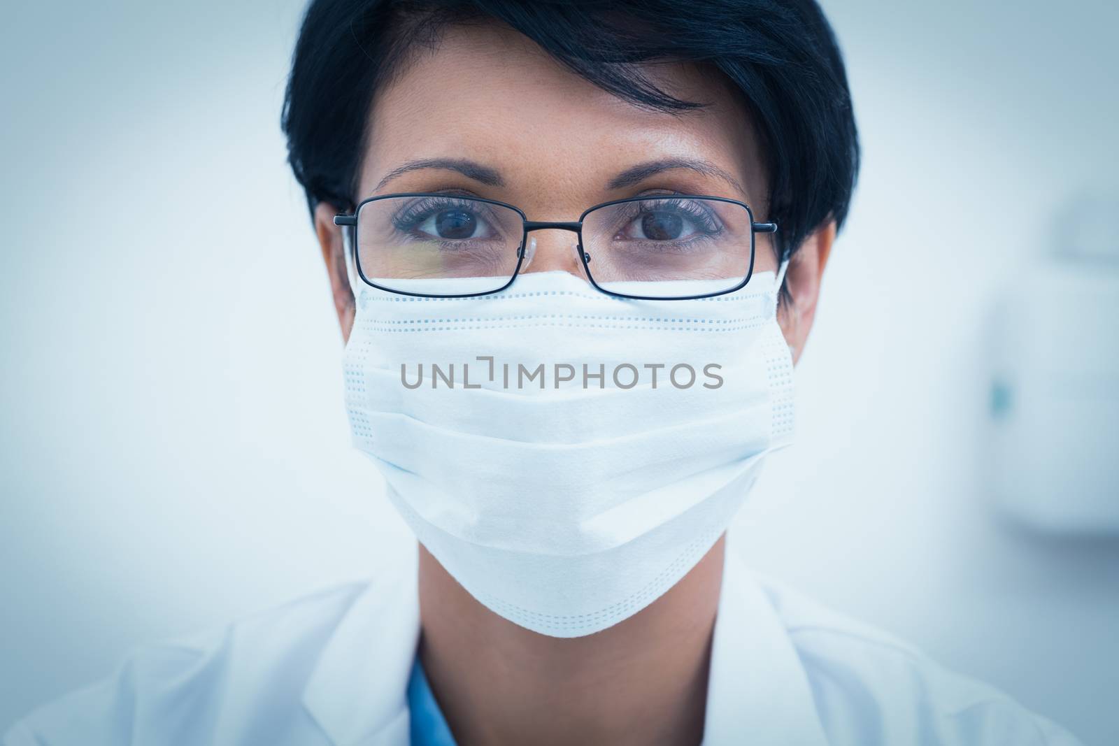 Female dentist wearing surgical mask by Wavebreakmedia