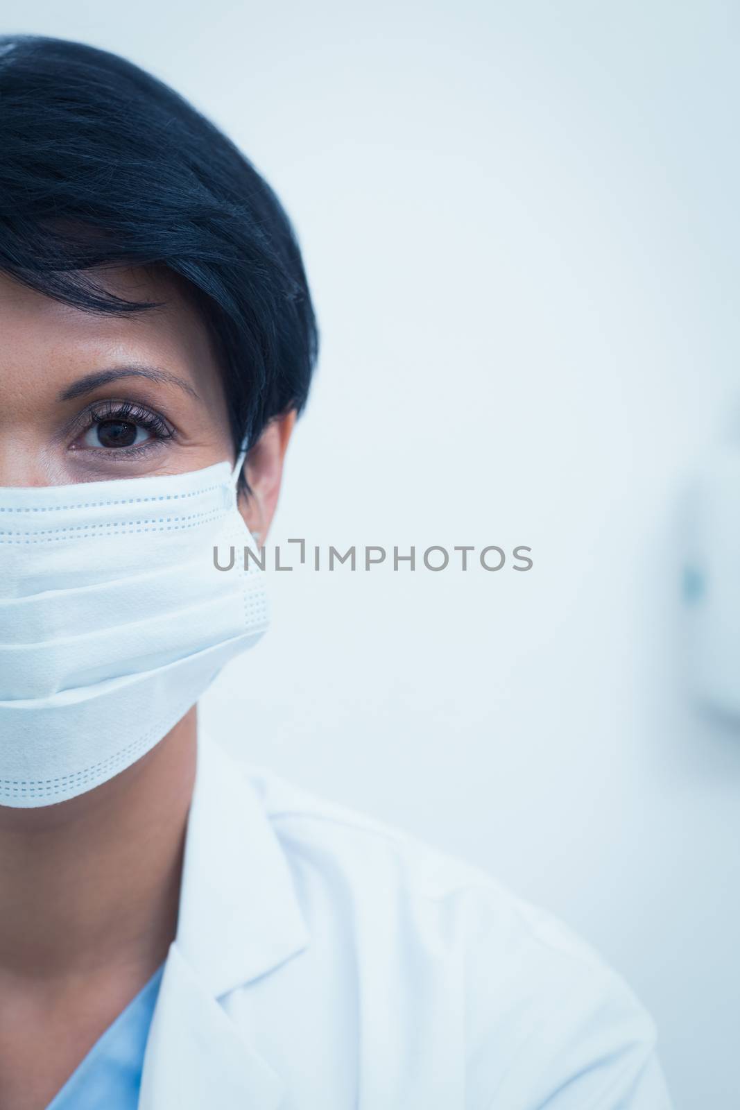 Female dentist wearing surgical mask by Wavebreakmedia
