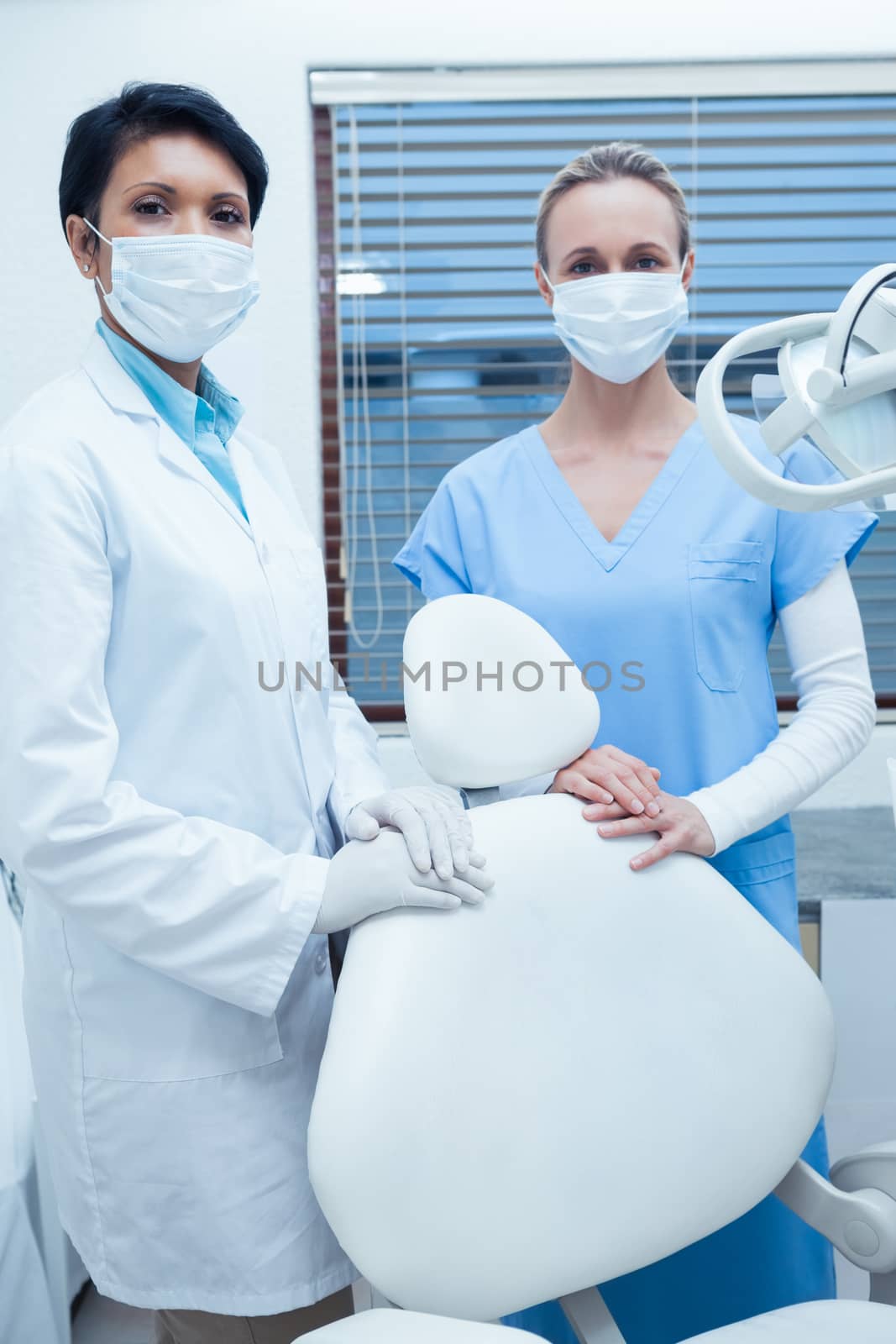 Female dentists wearing surgical masks by Wavebreakmedia