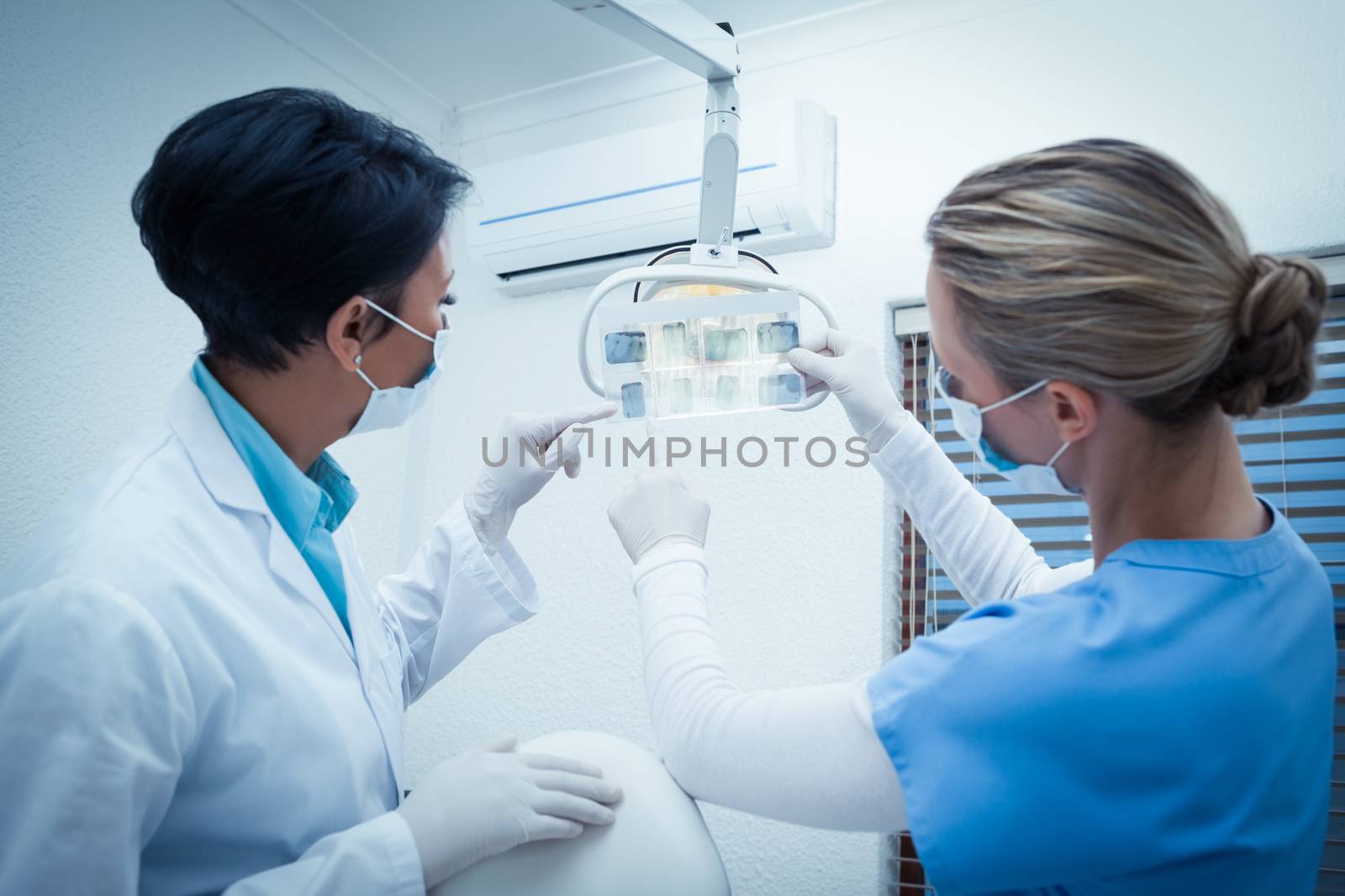 Two female dentists looking at x-ray