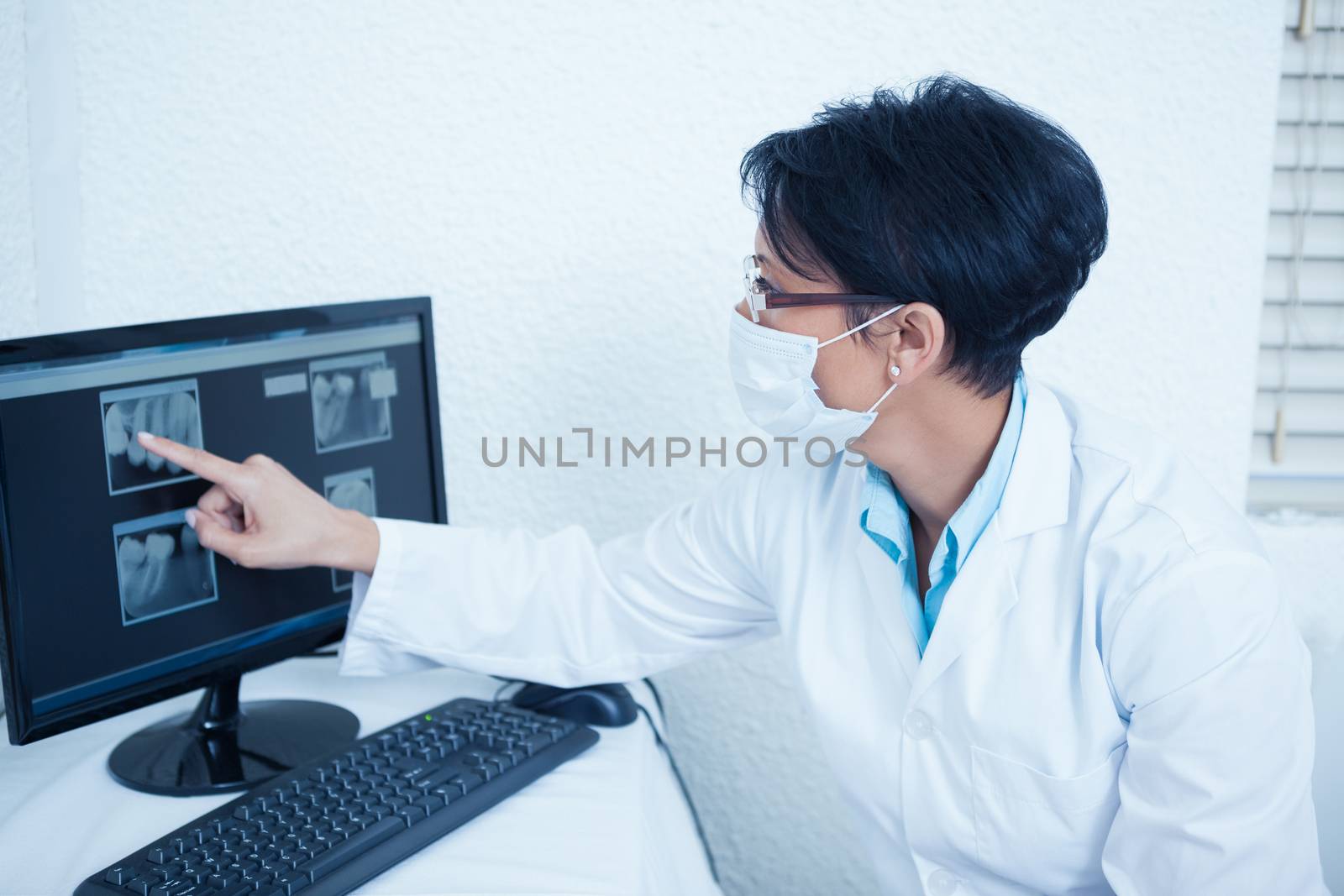 Female dentist looking at x-ray on computer by Wavebreakmedia