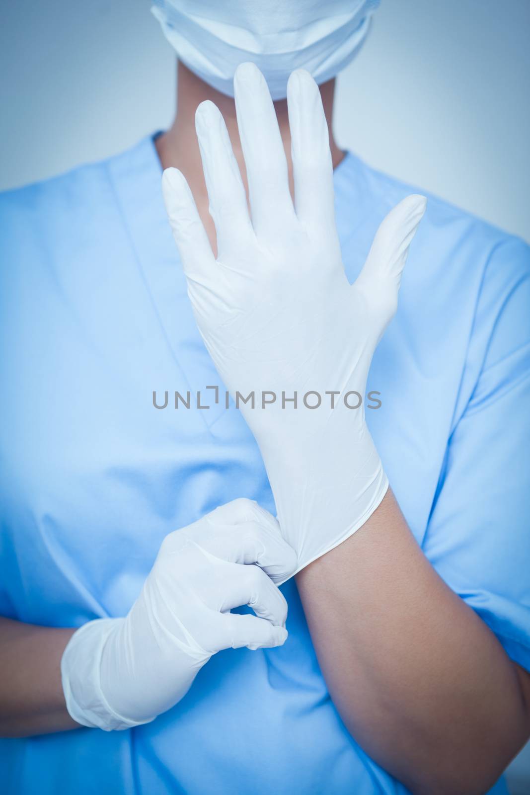 Female dentist wearing surgical glove by Wavebreakmedia