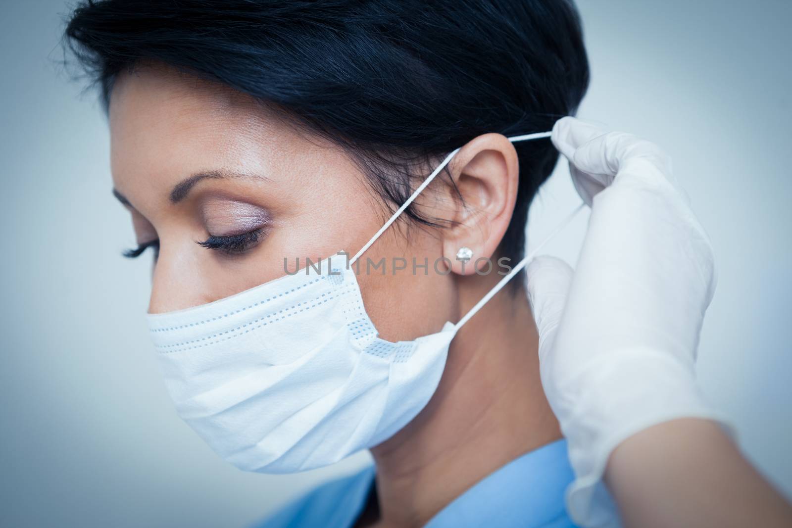 Female dentist wearing surgical mask by Wavebreakmedia
