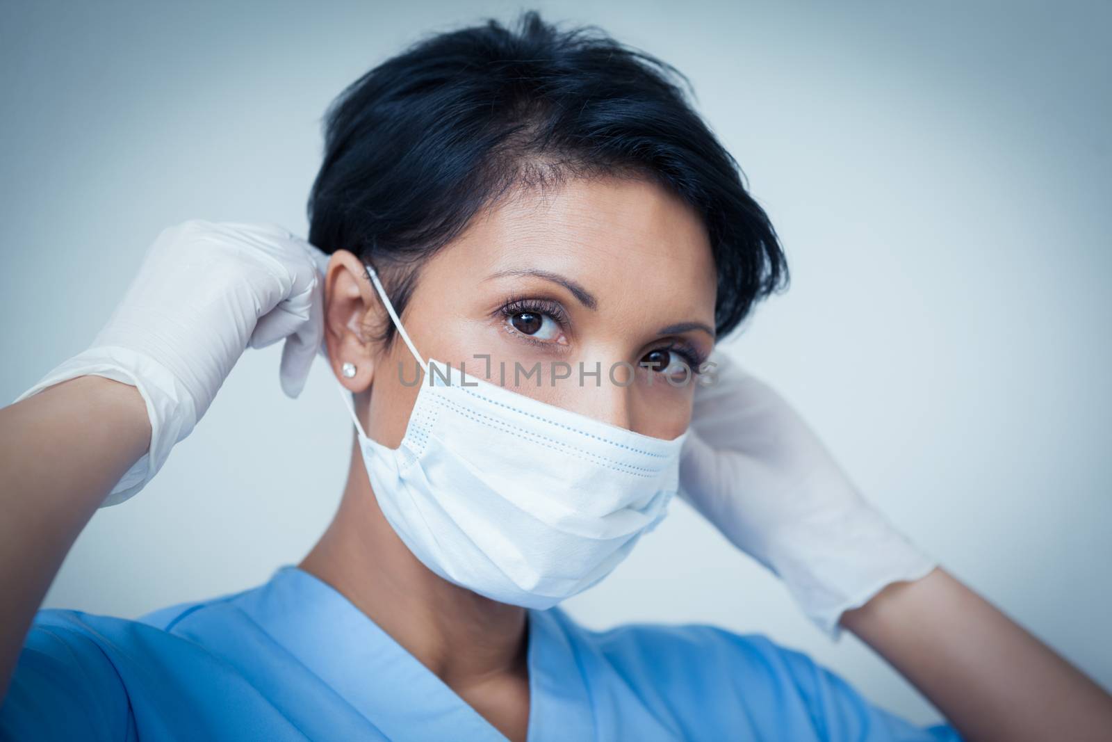 Female dentist wearing surgical mask by Wavebreakmedia