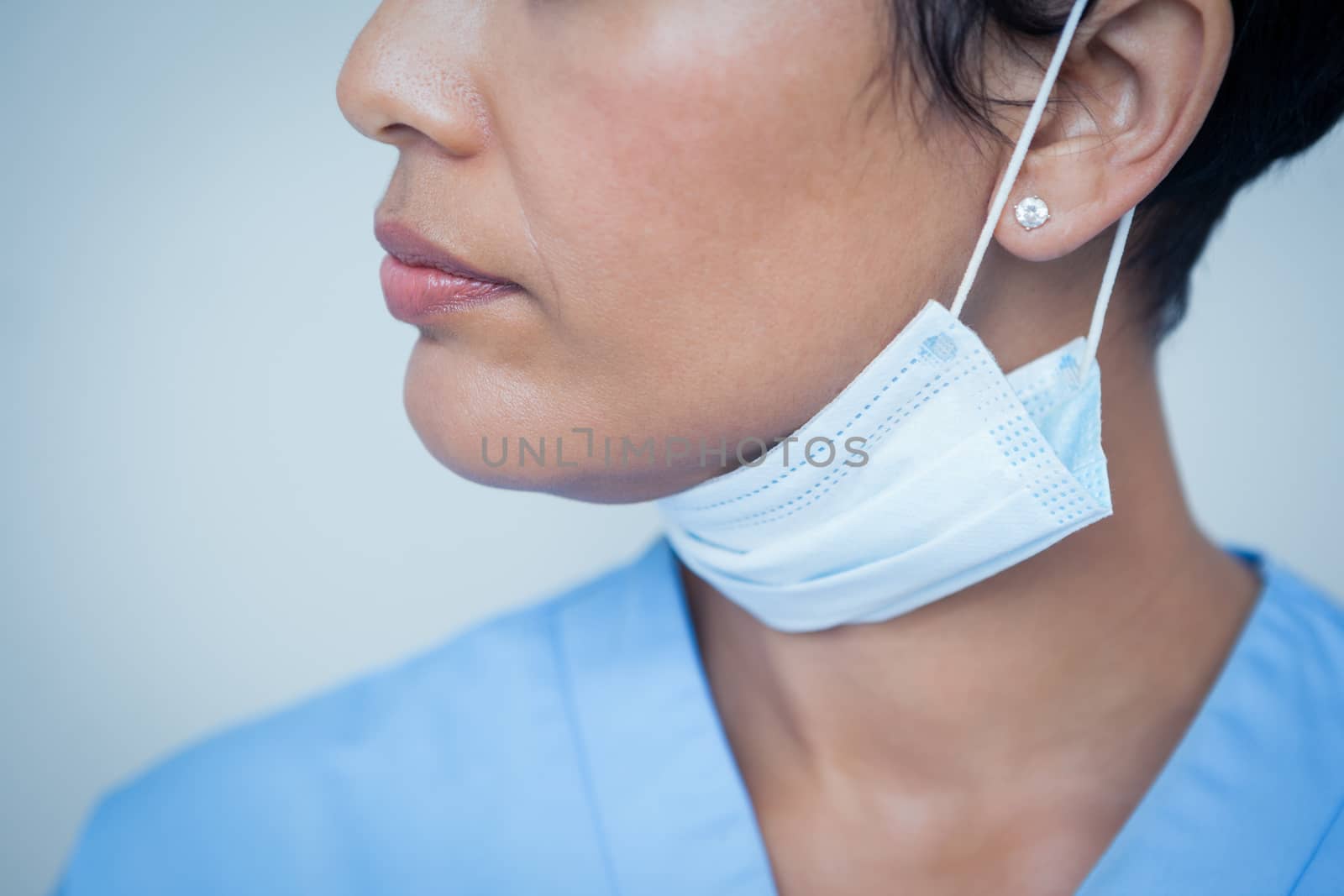 Close up mid section of female dentist wearing surgical mask