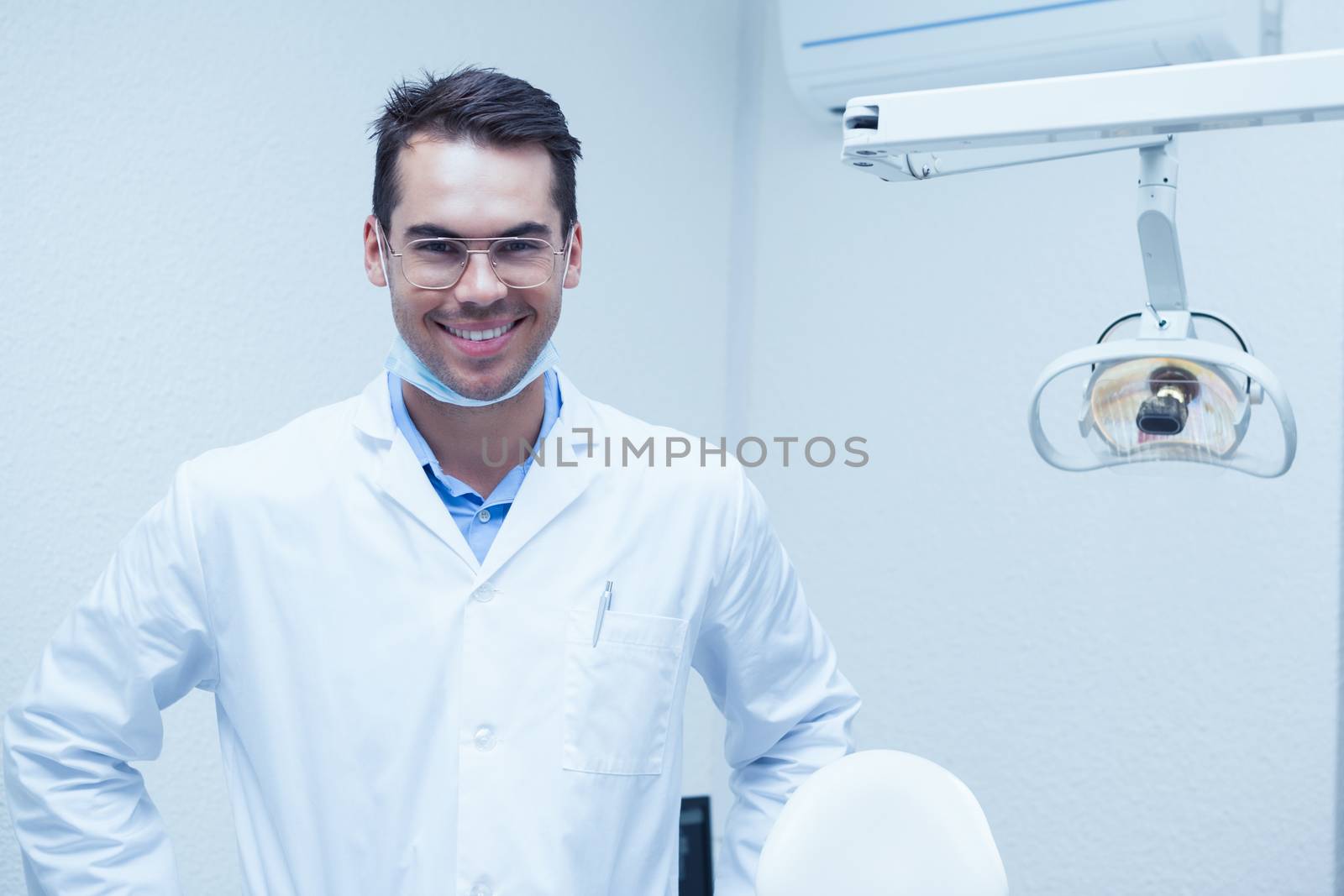 Portrait of smiling male dentist by Wavebreakmedia