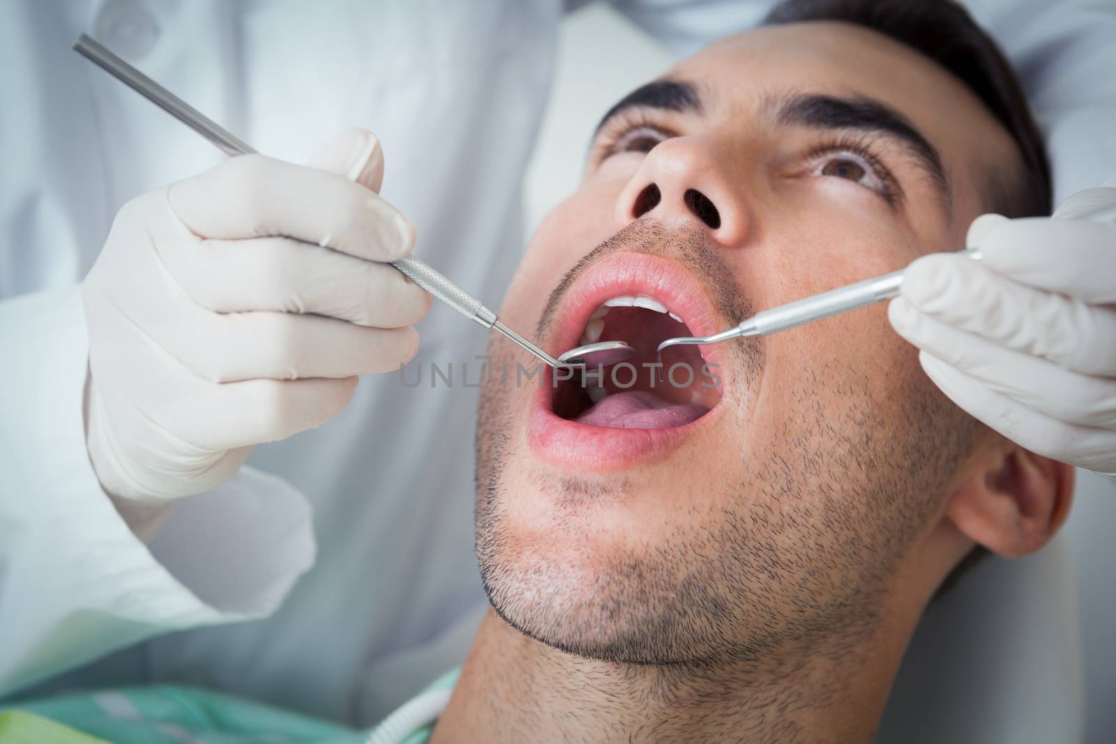 Close up of man having his teeth examined by Wavebreakmedia