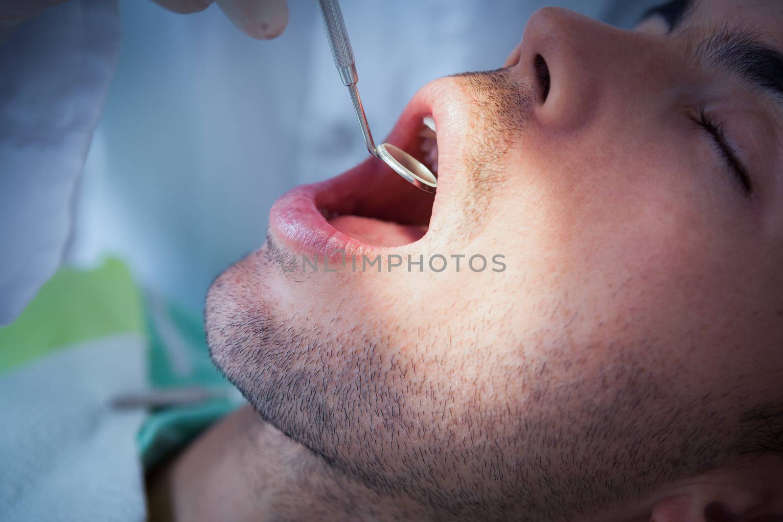 Close up of man having his teeth examined by Wavebreakmedia