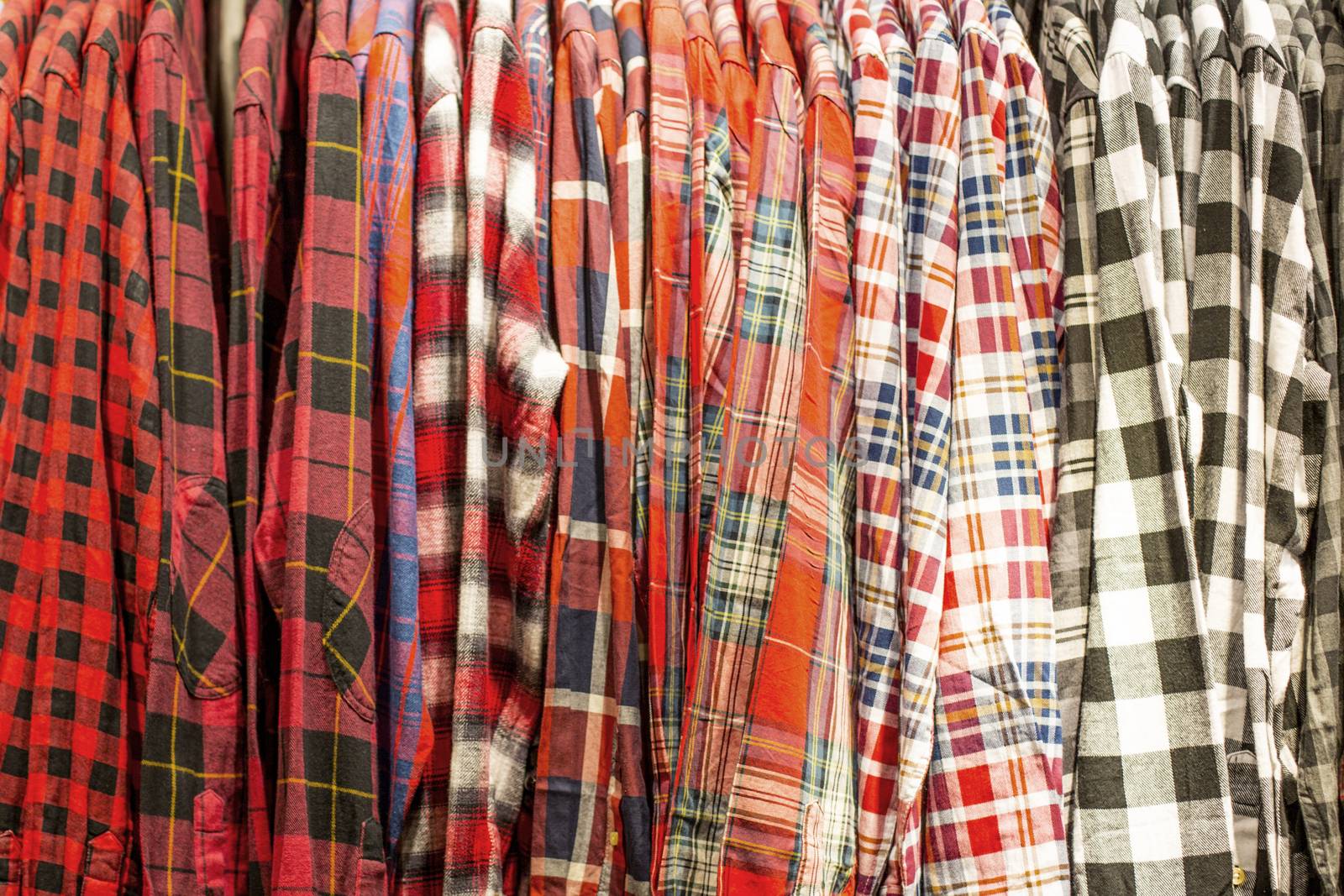 Shop Hanging Rail With Coloured Checked Mens Shirts by Whiteboxmedia