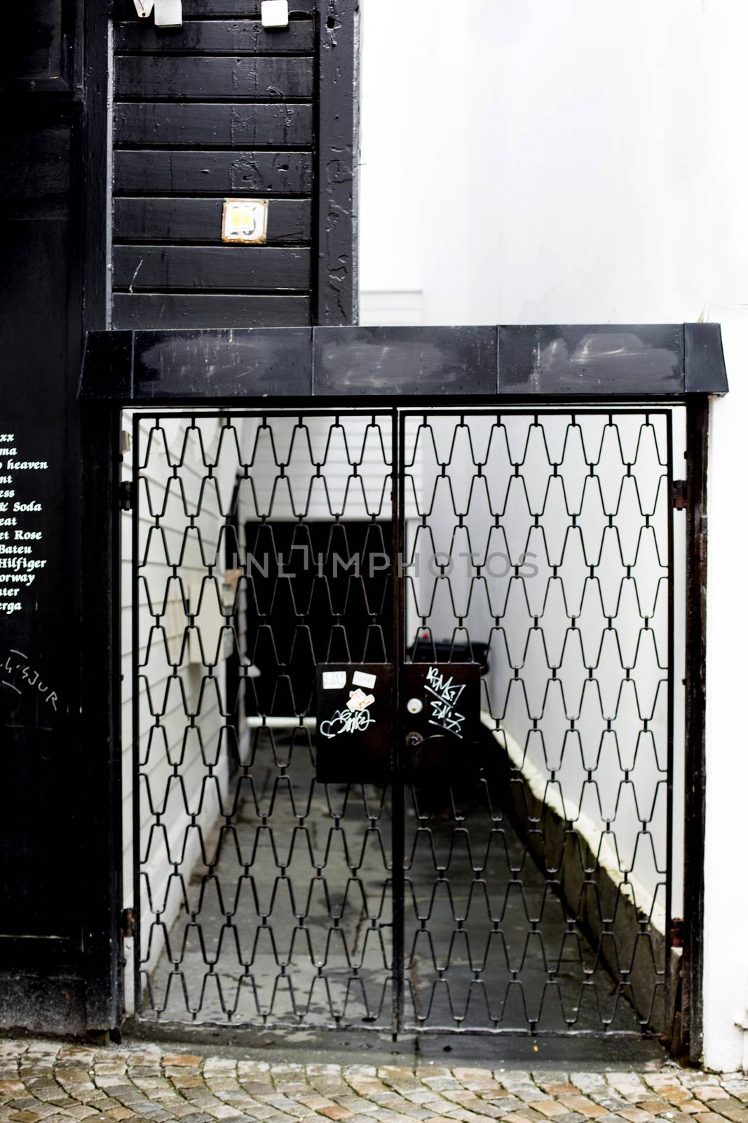 Black Steel Security Gate Protecting a Private Alley Old Town St by Whiteboxmedia