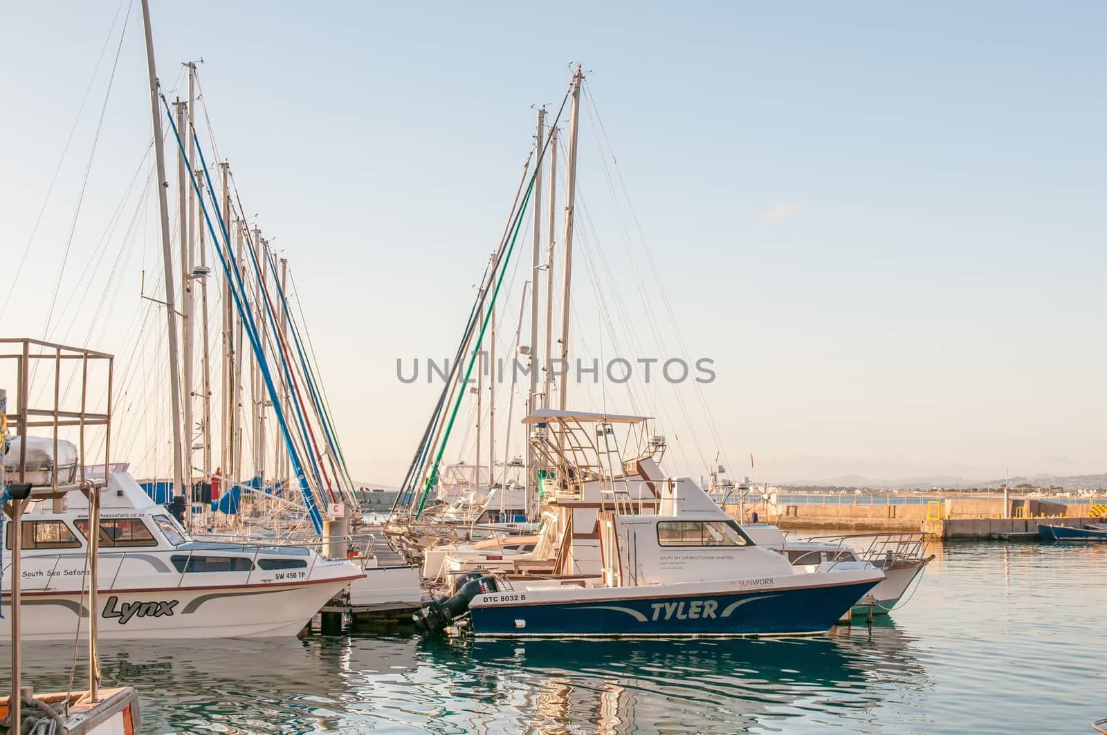 CAPE TOWN, SOUTH AFRICA - DECEMBER 11, 2014:  Boats at the harbor in Gordons Bay at sunset