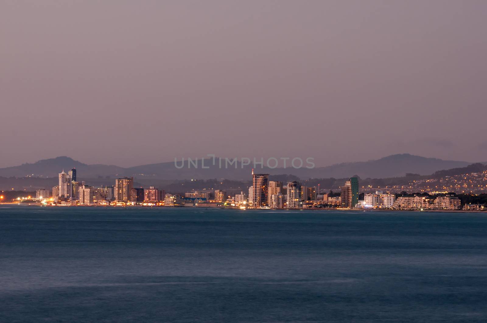 CAPE TOWN, SOUTH AFRICA - DECEMBER 11, 2014:  The Strand (the beach) after sunset as seen from the start of Clarence Drive