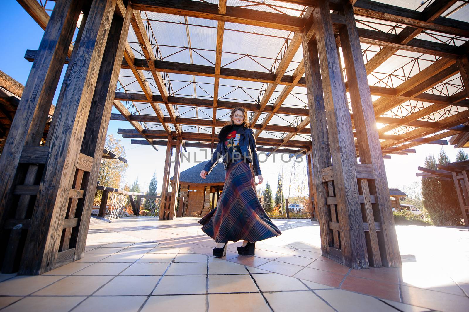 portrait of a beautiful girl on a background of the wooden building