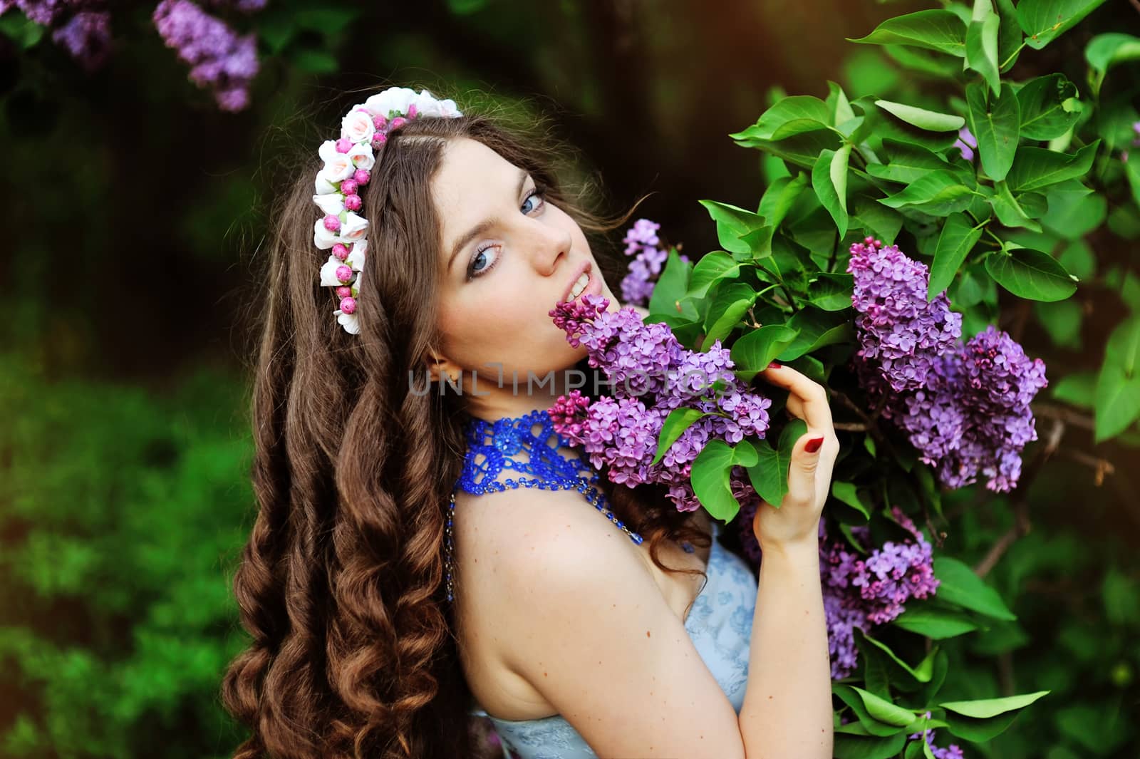 beautiful young girl on a background of flowering trees