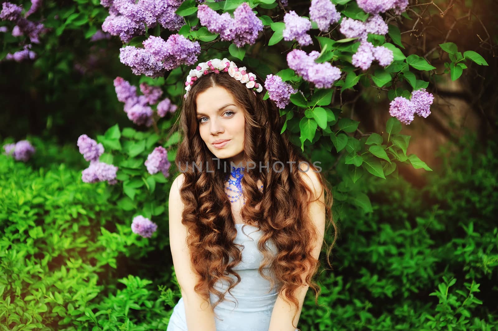 beautiful young girl on a background of flowering trees