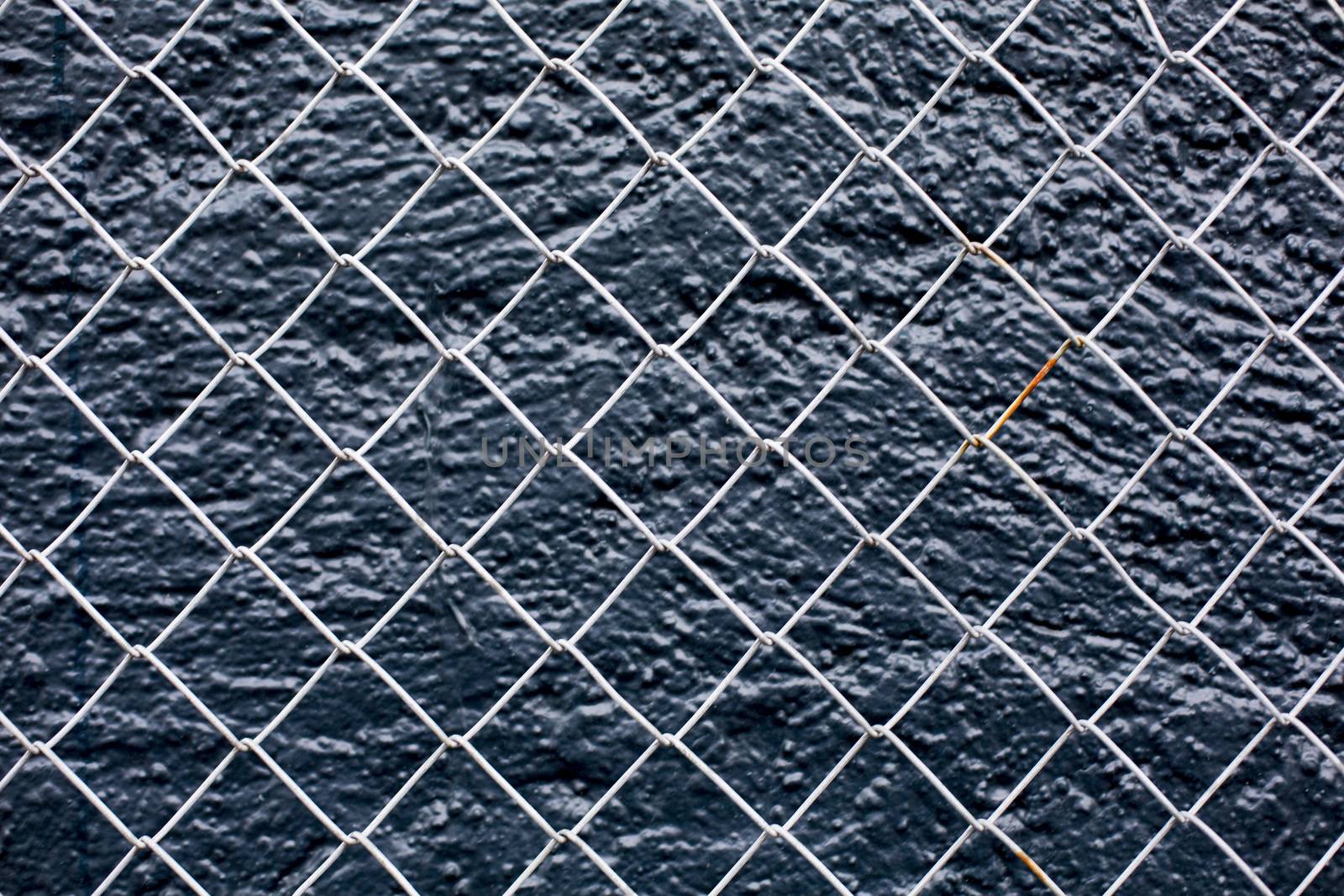 Wire Fence Tight Against A Black Background