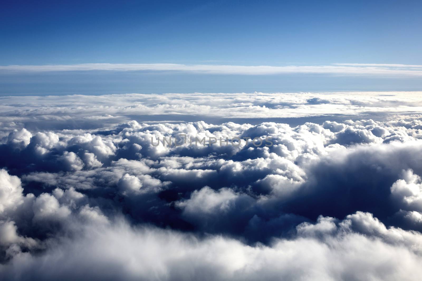 Looking Down at White Fluffy CLouds Against a Blue Sky by Whiteboxmedia
