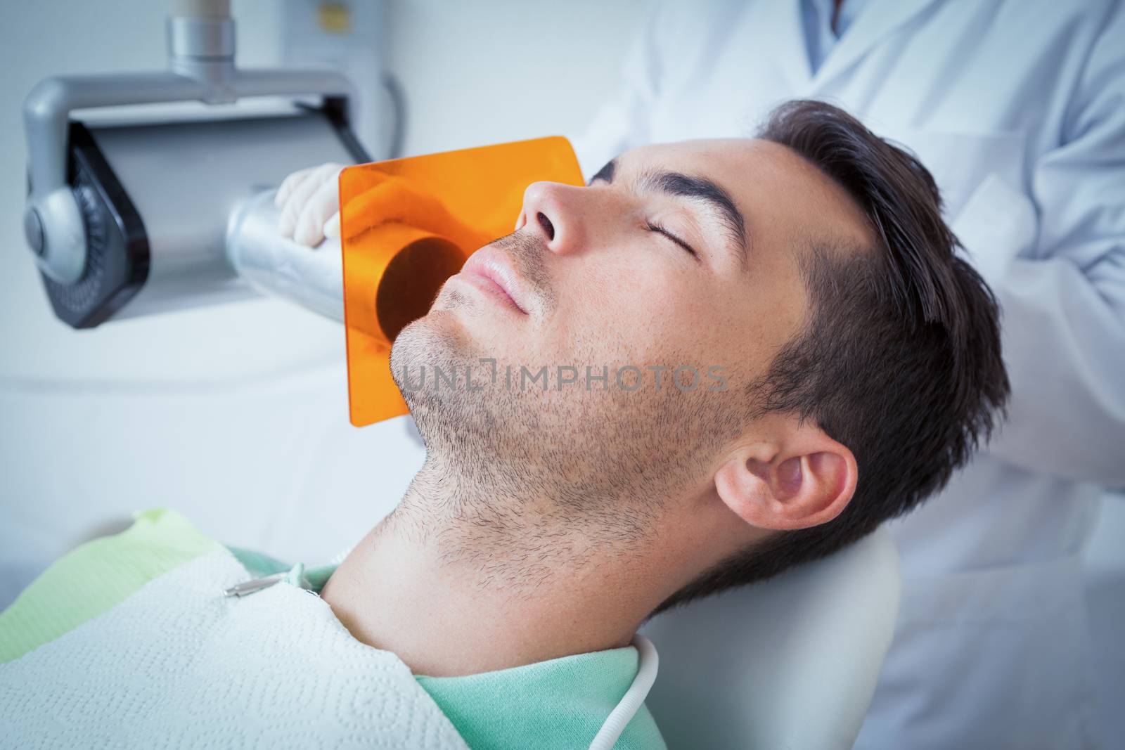 Close up of young man undergoing dental checkup in the dentists chair