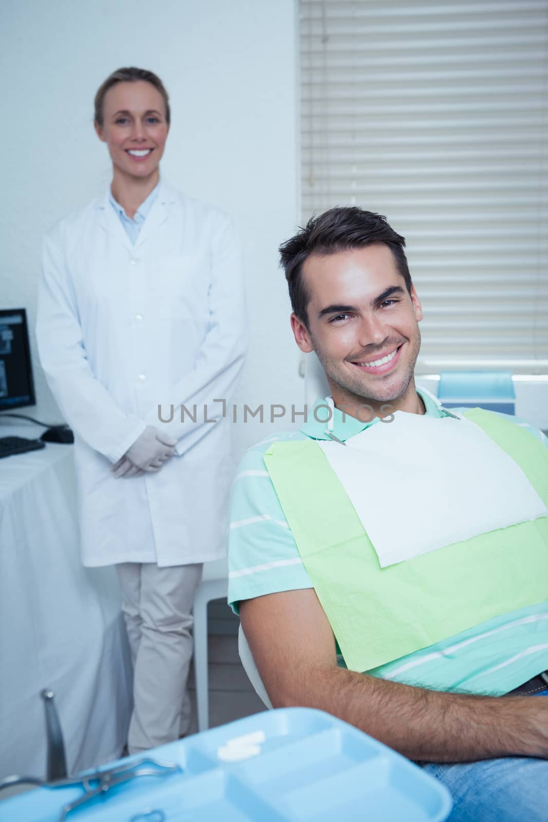 Portrait of smiling young man waiting for a dental exam