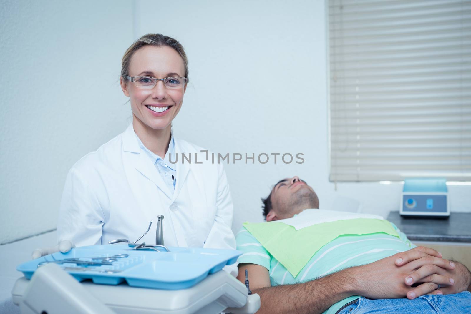 Smiling female dentist by Wavebreakmedia