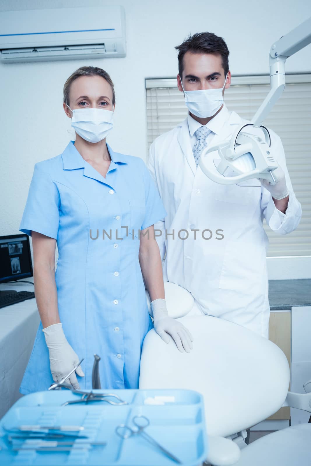 Portrait of male and female dentists wearing surgical masks
