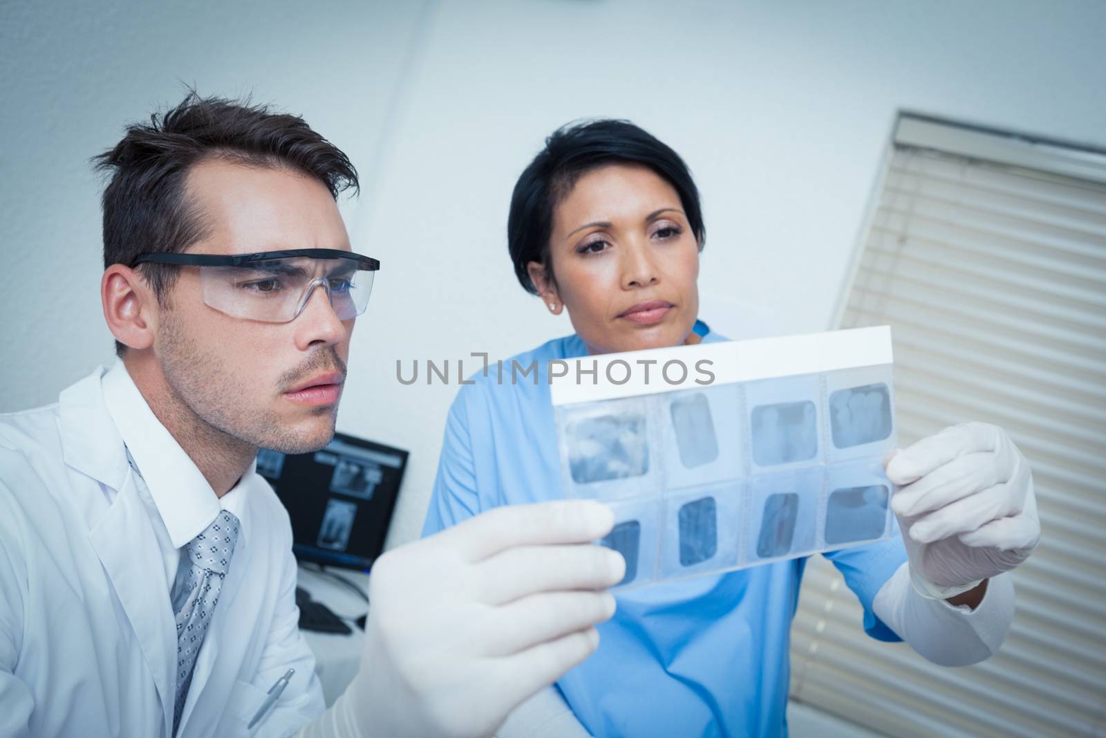 Concentrated two dentists looking at x-ray