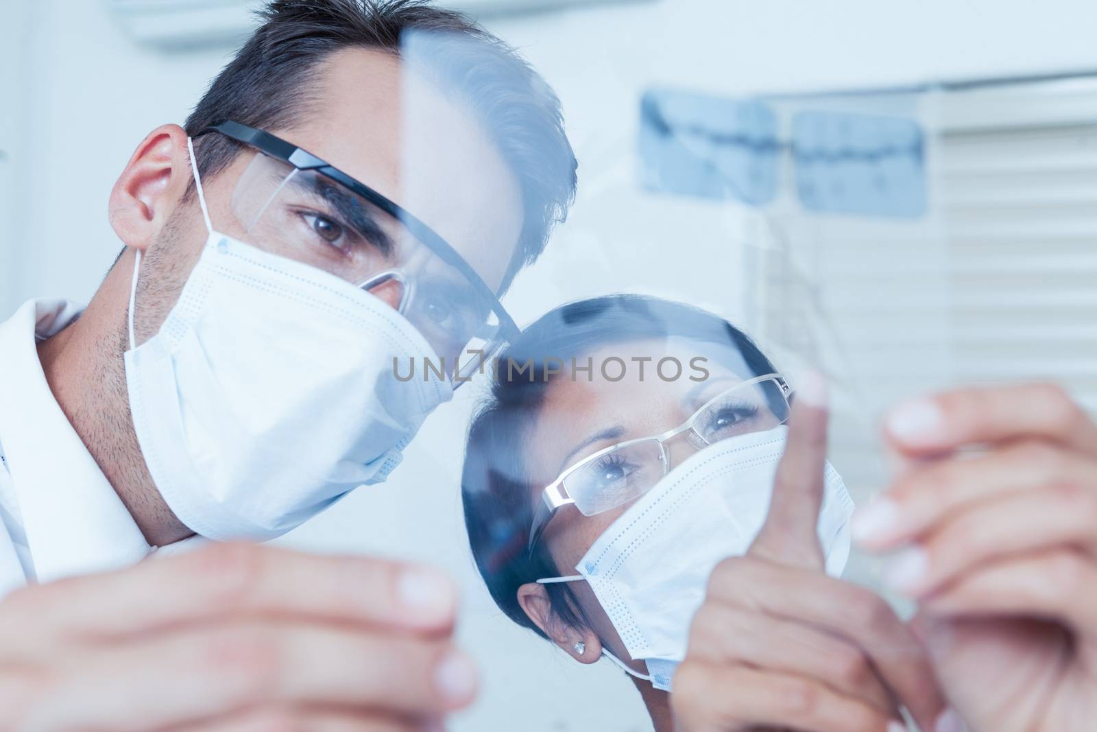 Dentists looking at x-ray by Wavebreakmedia