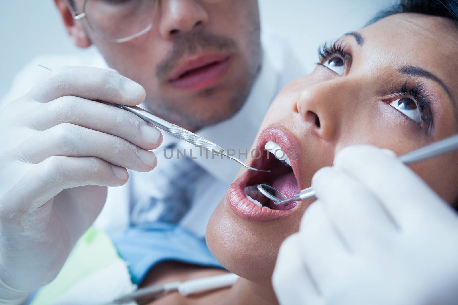 Close up of woman having her teeth examined by dentist